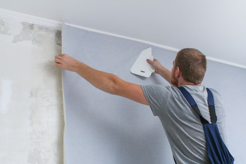 Professional wallpaper installers preparing walls